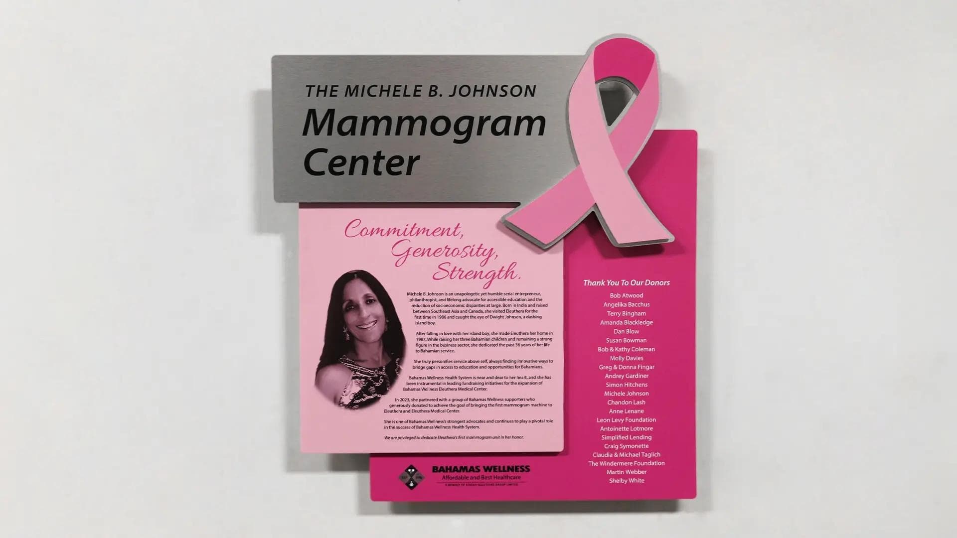 Mammogram Center donor recognition wall with pink ribbon artwork, layered panels, and donor list honoring breast cancer support.