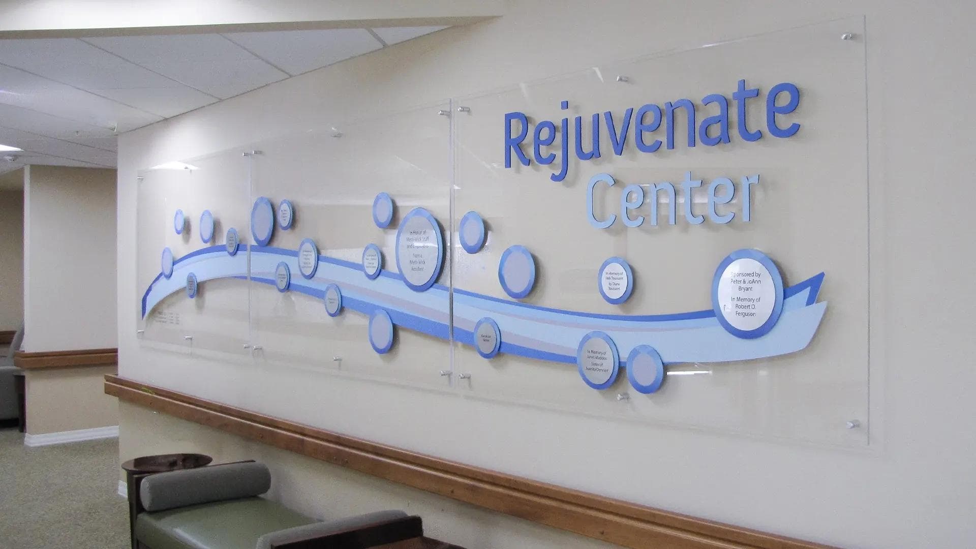 Rejuvenate and Aquatic Center donor wall at Methwick Retirement Community with flowing graphics and circular donor bubbles.