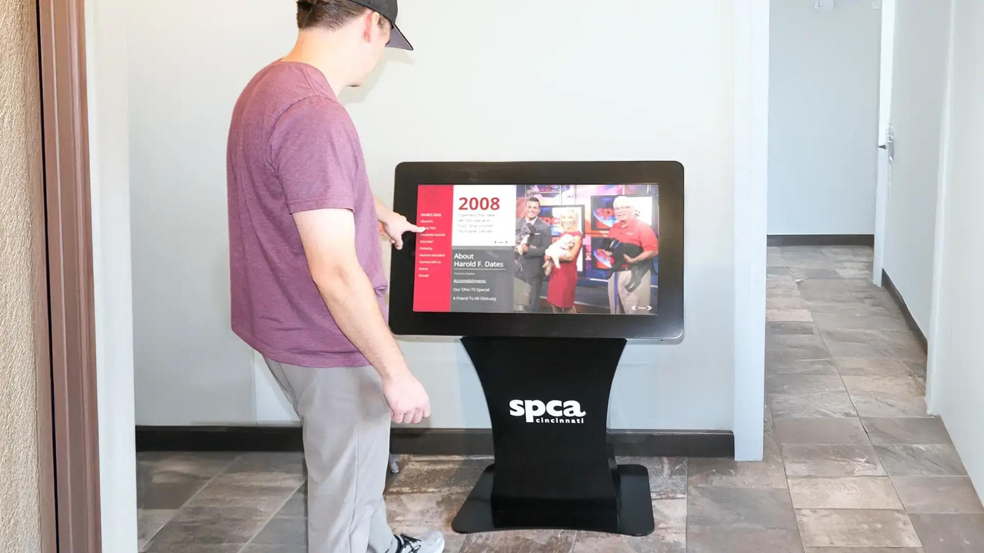 Interactive donor recognition touchscreen kiosk for SPCA Cincinnati displaying donor stories and timelines in a custom freestanding digital kiosk.