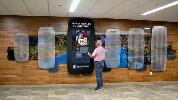 Digital Recognition Donor Wall With Custom Mural Photographic Scene. Interactive Display to read about donors, programs and recognize all donations made to the hospital